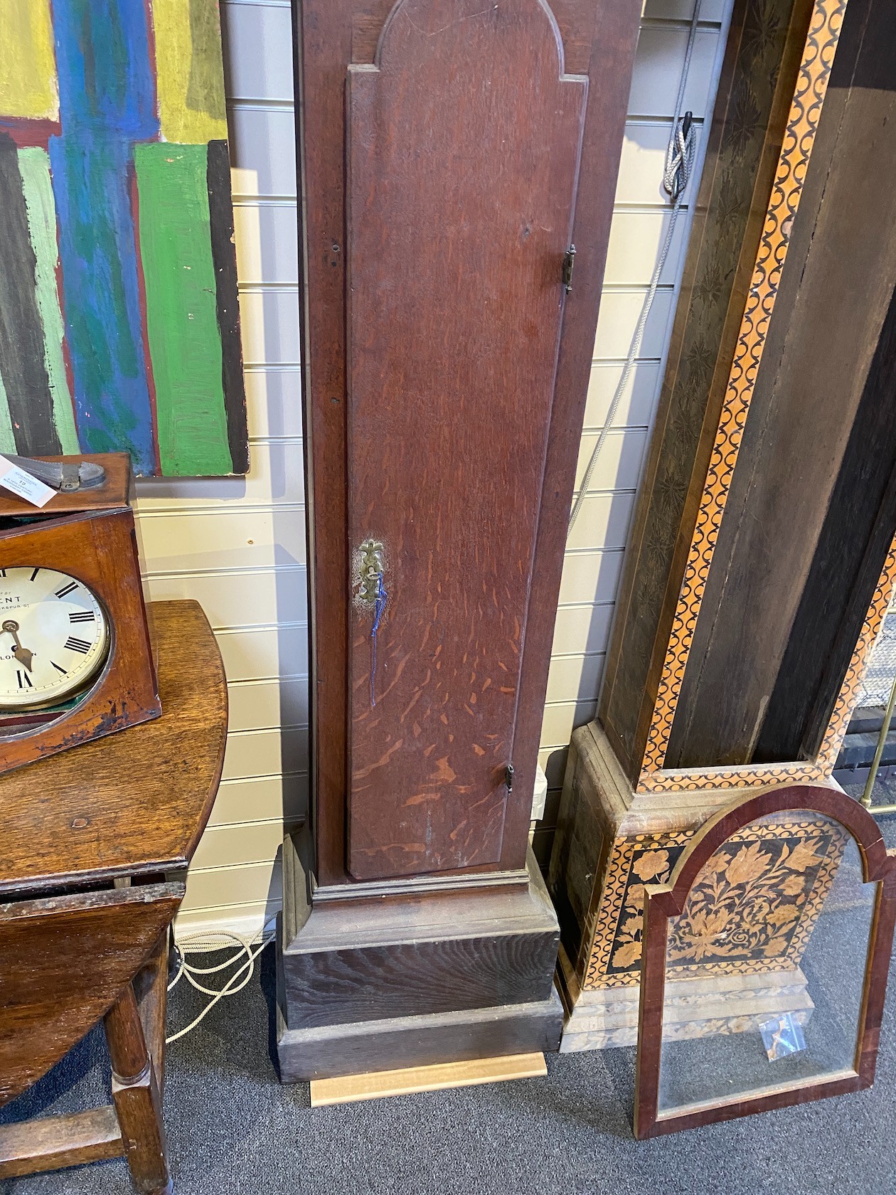 A George III oak longcase clock case and an inlaid clock case, larger 222 cm high.